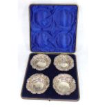 A CASED SET OF FOUR VICTORIAN CIRCULAR SILVER BONBON DISHES With pierced and embossed decoration