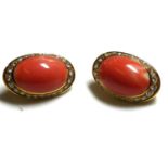 A PAIR OF 18CT GOLD CORAL AND DIAMOND CLIP EARRINGS The single cabochon cut coral, edged with