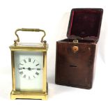 A LATE 19TH/EARLY 20TH CENTURY BRASS CARRIAGE CLOCK With bevelled glass enclosing a white