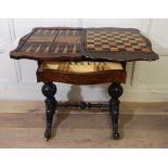 A VICTORIAN WALNUT WORK/GAMES TABLE The shaped top opening to reveal inlaid chess and backgammon