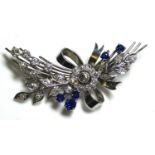 AN 18CT WHITE GOLD, DIAMOND AND SAPPHIRE SPRAY BROOCH The floral display of round cut diamonds,