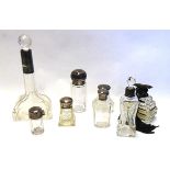 A COLLECTION OF SEVEN EARLY 20TH CENTURY SILVER AND CUT GLASS TRINKET BOTTLES A tall bottle with