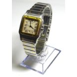 CARTIER, SANTOS, A STAINLESS STEEL GENT?S WRISTWATCH Having a square cut dial with gold plated