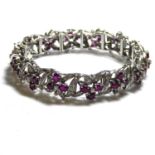 A 14CT WHITE GOLD, RUBY AND DIAMOND BRACELET Each link set with oval cut rubies and round cut