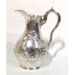 A VICTORIAN SILVER BALUSTER CREAM JUG With embossed floral decoration, hallmarked London, 1865. (