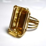 AN 18CT GOLD AND LARGE CITRINE RING Faceted rectangular cut stone, held in four claw mount and