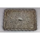 AN EDWARDIAN SILVER RECTANGULAR TRINKET TRAY With embossed scrolled decoration, hallmarked