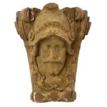 A 19TH CENTURY CARVED WOODEN CORBEL Facial mask of a Medieval knight, partial French grey painted