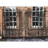 A GOOD PAIR OF VICTORIAN HEAVY WROUGHT IRON DRIVEWAY GATES With scrollwork, florets and turned