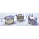 A COLLECTION OF THREE VICTORIAN SILVER MUSTARD POTS Comprising an oval pot with pierced