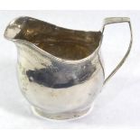 A GEORGIAN SILVER HELMET FORM CREAM JUG With bright cut engraved decoration, hallmarked George