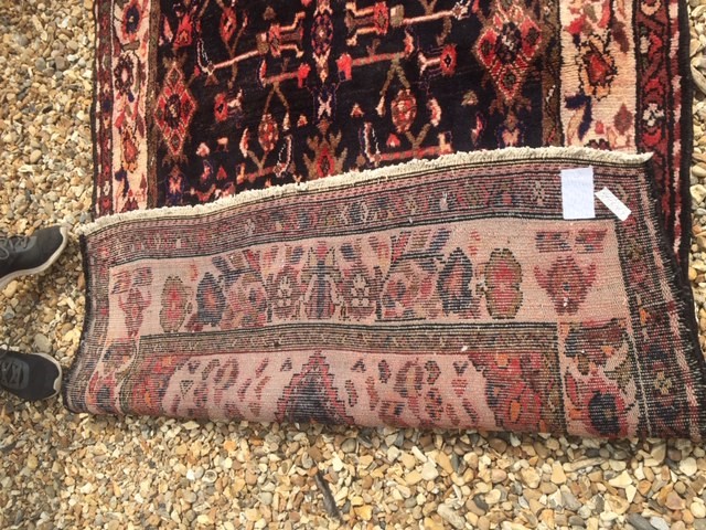 A MIDDLE EASTERN DESIGN RUG Having floral and zoomorphic motifs to central field, contained within a - Image 2 of 2