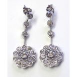 A PAIR OF 18CT WHITE GOLD AND DIAMOND CLUSTER PENDANT EARRINGS The arrangement of round cut diamonds