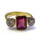 AN 18CT GOLD, RUBY AND DIAMOND THREE STONE RING The single emerald cut ruby flanked by two round cut