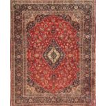 A KURK KASHAN WOOLLEN RUG OF CARPET PROPORTIONS The pendant medallion and floral decoration on a red