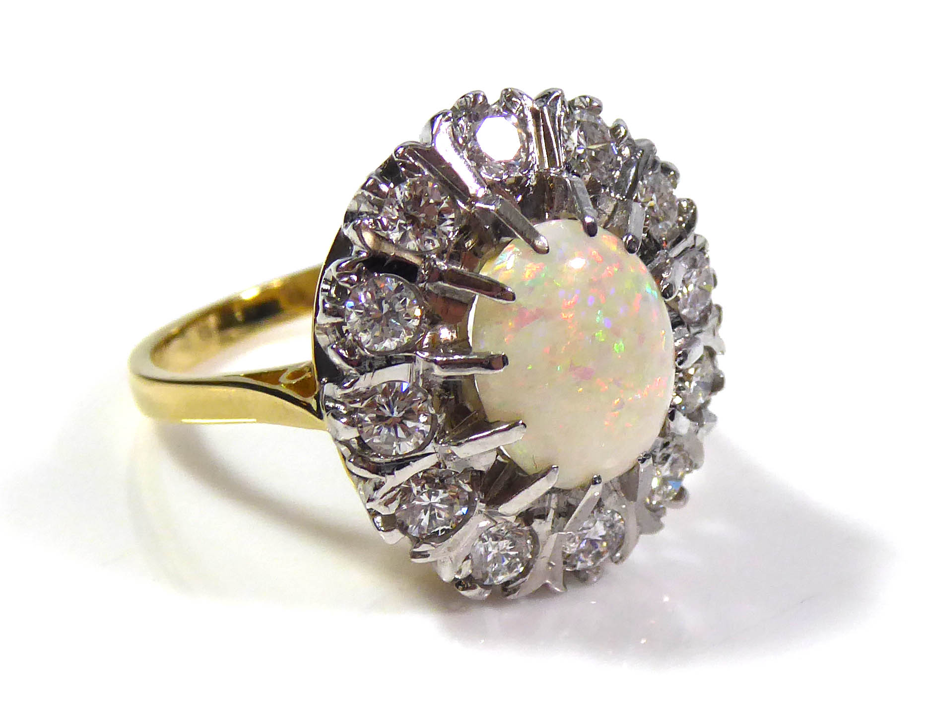 AN 18CT GOLD, OPAL AND DIAMOND CLUSTER RING Having a cabochon cut opal edged with round cut diamonds