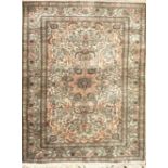 A PERSIAN ISFAHAN SILK RUG Floral motifs on a cream ground contained within a running border. (