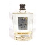 AN EARLY 20TH CENTURY FRENCH GLASS BOTTLE OF EAU DE COLOGNE Rectangular form, bearing label ?Eau