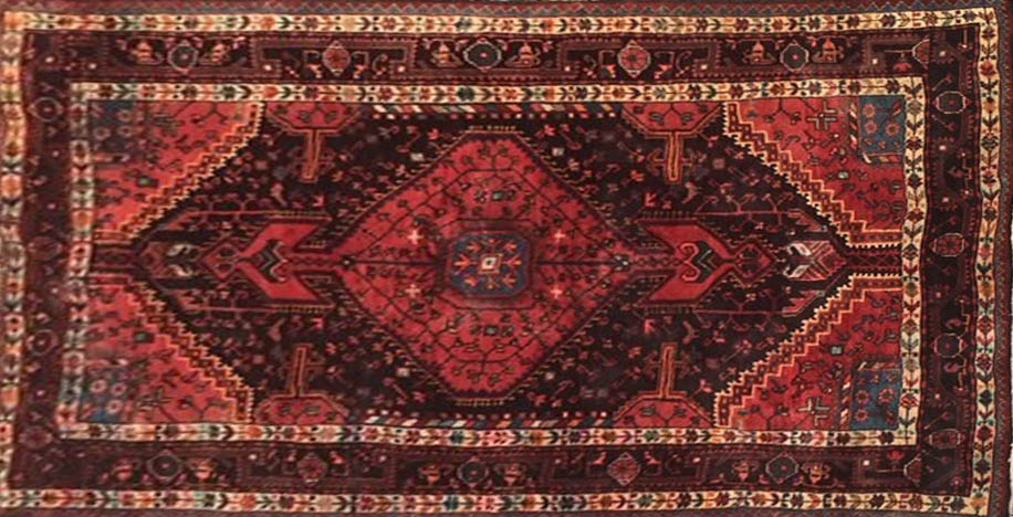 A MIDDLE EASTERN DESIGN WOOLLEN RUG With pendant medallion amongst floral motifs contained within