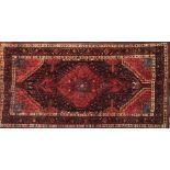 A MIDDLE EASTERN DESIGN WOOLLEN RUG With pendant medallion amongst floral motifs contained within