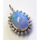 A WHITE METAL, OPAL AND DIAMOND PENDANT Having a single cabochon cut opal edged with diamonds. (