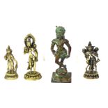 AN EARLY 20TH CENTURY SOLID BRONZE STATUE OF A HINDU GOD Along with three white metal Hindu statues.