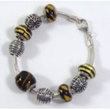 LOVELINKS, A SILVER AND MURANO GLASS BRACELET The fancy spherical links set with yellow and black