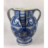 AN IZNIK POTTERY FOUR HANDLED BALUSTER FORM VASE With underglaze blue floral decoration. (approx