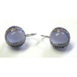 A PAIR OF 18CT WHITE GOLD, MOONSTONE AND DIAMOND EARRINGS Having a cabochon cut stone edged with