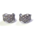 A PAIR OF 18CT WHITE GOLD AND DIAMOND EARRINGS Pavé set stones in a twist design. (approx 1.5cm x