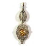 AN EARLY 20TH CENTURY 18CT GOLD, DIAMOND AND CITRINE PENDENT The oval cut citrine edged with round