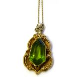 A VICTORIAN YELLOW METAL, PERIDOT AND SEED PEARL PENDANT Having a lozenge form stone in a scrolled