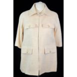 CHANEL, CREAM TWEED LOOSE FITTING JACKET With four front pockets with mother of pearl buttons, cream