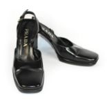 PRADA, BLACK LEATHER HEELS With a rectangular slight platform, ankle strap and square toe (size 39).