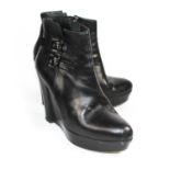 THE KOOPLES, BLACK LEATHER WEDGE BOOTS With a side zip, two silver buckles (size 39). (heel 11.