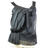 NINA RICCI, BLACK SILK VEST With ruffled black fabric on front, beaded crossover design on back,