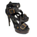 BURBERRY, BLACK LEATHER SANDALS With brass buckles and cross over straps to front (size 39). (heel