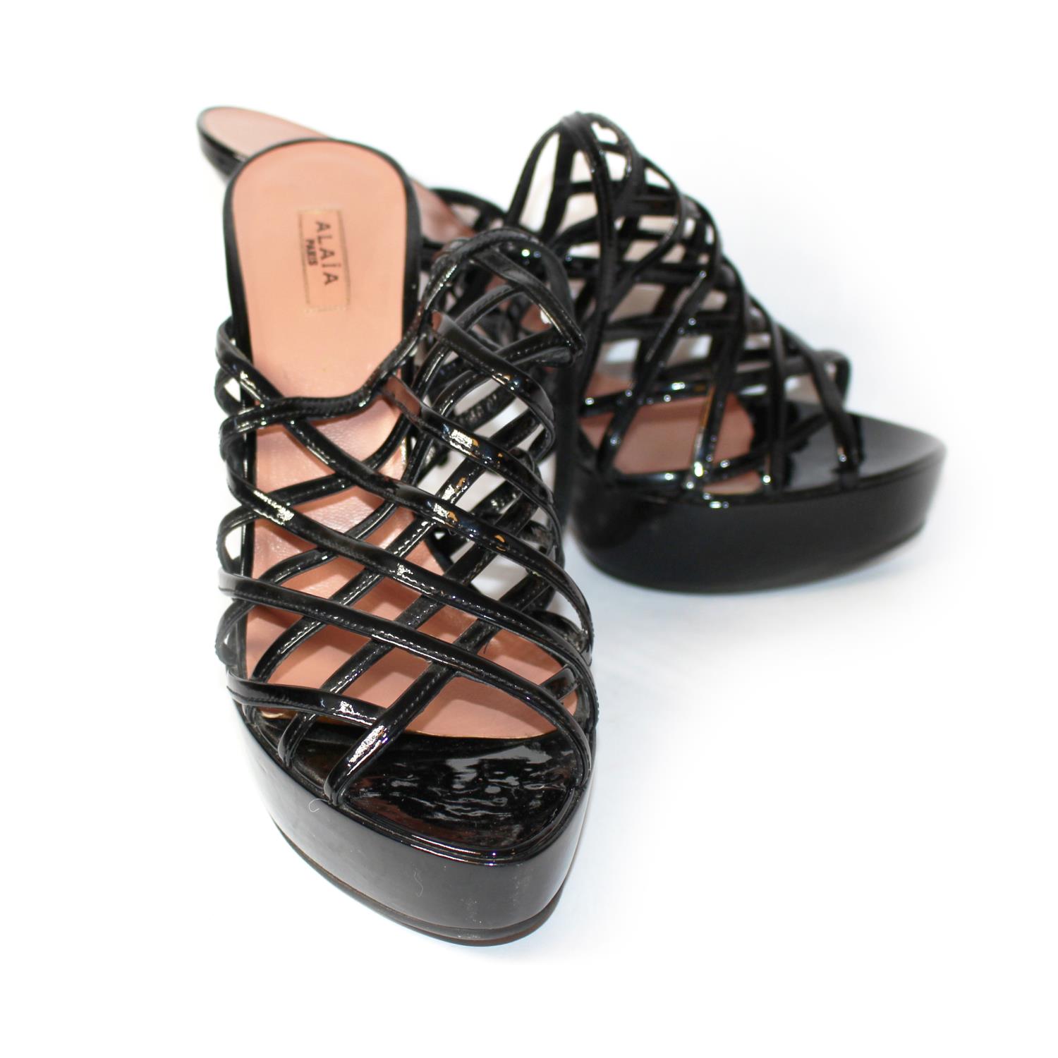 ALAÏA, PATENT LEATHER HEELS With lattice strapwork and tapering heel (size 39). (heel 12cm) A