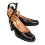VIVIENNE WESTWOOD, BLACK LEATHER HEELS With ankle strap, wide heel and rounded toe. (heel 10.5cm)