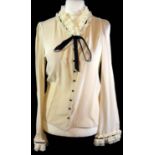 BALENCIAGA, SILK CREAM SHIRT With ruffled sleeves and collar, skinny black ribbon and black