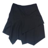 ALAÏA, BLACK WOOL SKIRT With asymmetric hemline, folded fabric along middle (size 40). A