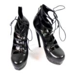 ALEXANDER MCQUEEN, BLACK ANKLE BOOTS With lace up front, cut out panels, spiral design along base