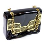 LARA BOHINC, BLACK PATENT LEATHER HANDBAG With golden chain handles, golden metal wave design, inner