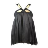 GUCCI, BLACK SILK DRESS With silver metal decorated straps and chest, layered skirt (size 42). A