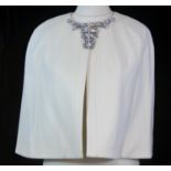 TED BAKER, CREAM WOOL SHOULDER CAPE With hook and eye fascinator at neck, gem embellishments along