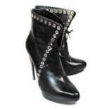 ALEXANDER MCQUEEN, BLACK LEATHER BOOTS With curved heel and white metal lace hole decoration (size