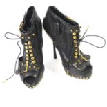 ALEXANDER MCQUEEN, BLACK LEATHER ANKLE BOOTS With lace up front, cut out sides, gold buckles on