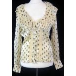 ALEXANDER MCQUEEN, CREAM SILK SHIRT With black skull design throughout, ruffled and lace decolletage