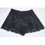 CHRISTIAN DIOR, BLACK SILK AND LACE SHORTS Zip side (size 10). A
