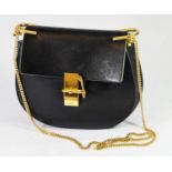 CHLOÉ, BLACK LEATHER SHOULDER BAG With golden chain and fastener. A